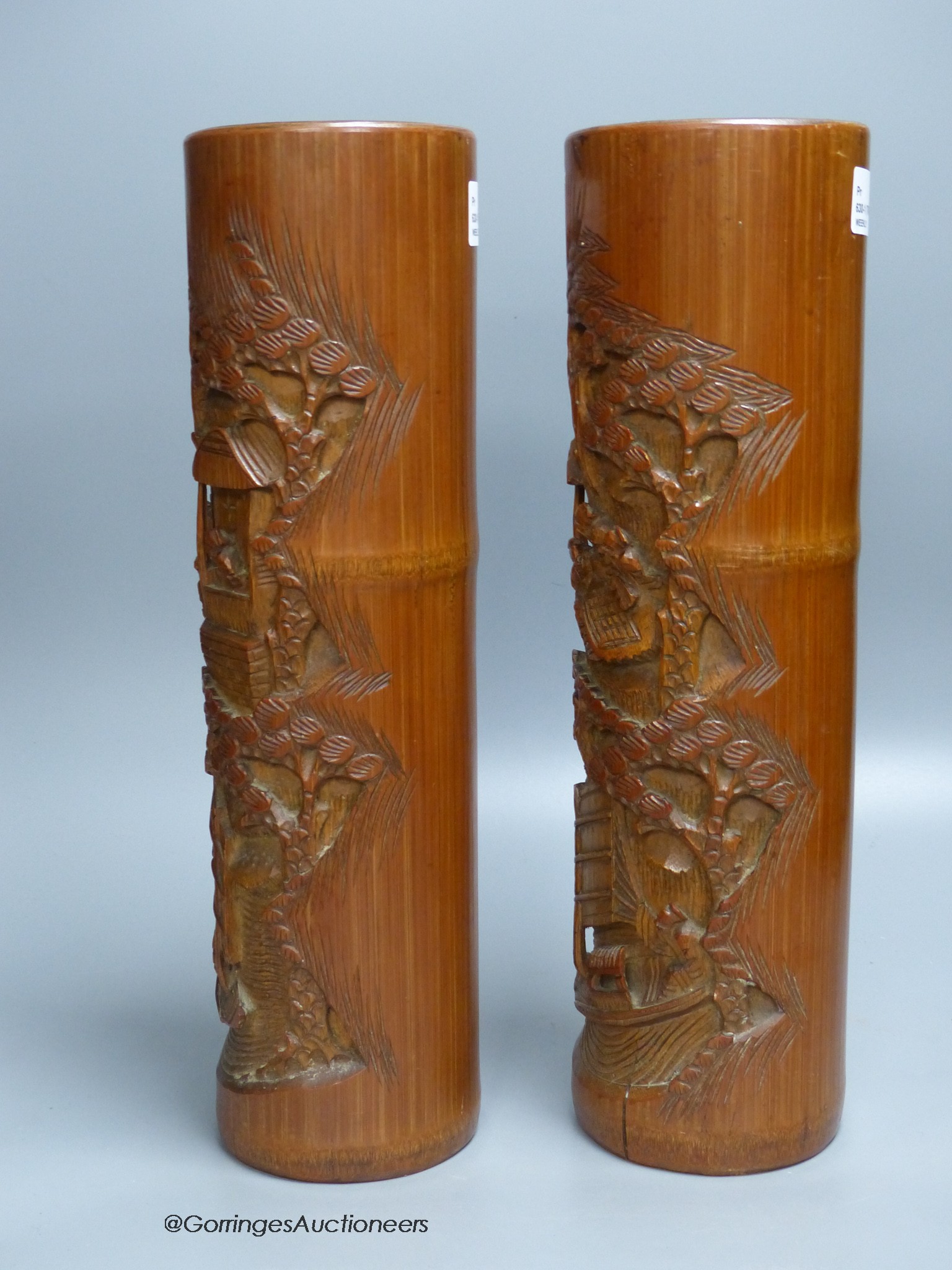 A pair of Chinese bamboo brush pots, carved with scholars in gardens, height 36cm